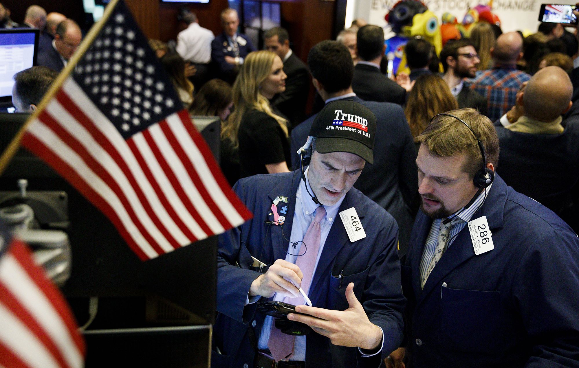 Tőzsdei kereskedő Trump sapkában a New York-i Értéktőzsdén 2017. november 30-án a kereskedési nap végén, miután a Dow Jones index először lépte át a 24.000 ponto szintet. EPA/JUSTIN LANE