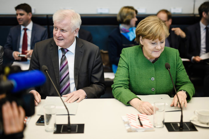 epa06689175 German Chancellor and Chairwoman of the Christian Democratic Union (CDU), Angela Merkel (R) and German Minister of Interior, Construction and Homeland and chairman of the German Christian Social Union (CSU) Horst Seehofer (L) sit next to each other during the beginning of a faction meeting in Berlin, Germany, 24 April 2018. The CDU/CSU faction meets on a regular basis at the German Parliament 'Bundestag'.  EPA/CLEMENS BILAN