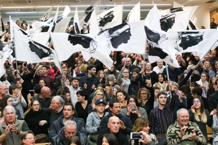 epa06358399 Supporters wave Corsican flags during a campaign meeting of the 'Pe a Corsica' (lit. Pour la Corse / eng. For Corsica) nationalist list ahead of the territorial elections in Corte, Corsica island, France, 29 November 2017. The elections will take place on 03 and 10 December in Corsica island.  EPA/OLIVIER SANCHEZ